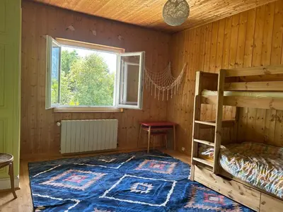 a room with a couch and a table and a window at La Flégère YourHostHelper in Chamonix-Mont-Blanc