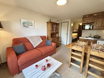 a living room with a couch and a table at Studio calme avec parking, vue montagnes, Demi-Quartier - FR-1-597-196 in Demi-Quartier