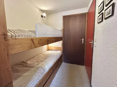 a small room with two bunk beds and a door at Studio calme avec parking, vue montagnes, Demi-Quartier - FR-1-597-196 in Demi-Quartier