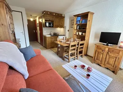 a living room with a red couch and a kitchen at Studio calme avec parking, vue montagnes, Demi-Quartier - FR-1-597-196 in Demi-Quartier