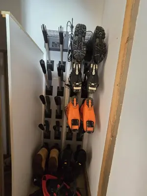a wall with a bunch of shoes and tools at Chalet du Lay Côte 2000 ski in ski out in Megève