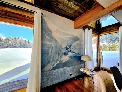 a room with a large painting on the wall at Chalet du Lay Côte 2000 ski in ski out in Megève