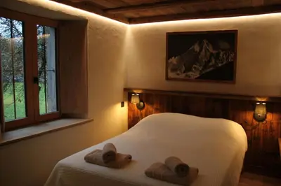 a bedroom with a bed with towels and a window at L'Ultime in Saint-Gervais-les-Bains