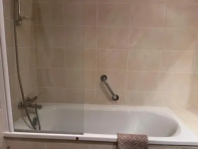 a bathroom with a tub with a shower at Chamonix cœur de ville - Aiguille du midi in Chamonix-Mont-Blanc