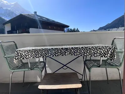a building on top of a wall with a bench at Chamonix cœur de ville - Aiguille du midi in Chamonix-Mont-Blanc