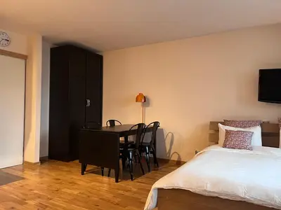 a bedroom with a bed and a desk and a table at Chamonix cœur de ville - Aiguille du midi in Chamonix-Mont-Blanc