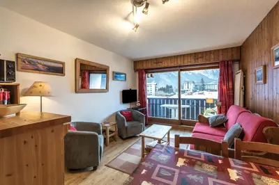 a living room with a couch and a table at Appartement Les Balcons du Savoy in Chamonix-Mont-Blanc
