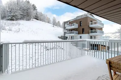 a balcony of a building with snow on the ground at Les Ecrins de Kayla -Piscine - Sauna in Les Houches