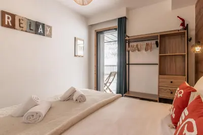 a bedroom with a bed with towels on it at Les Ecrins de Kayla -Piscine - Sauna in Les Houches