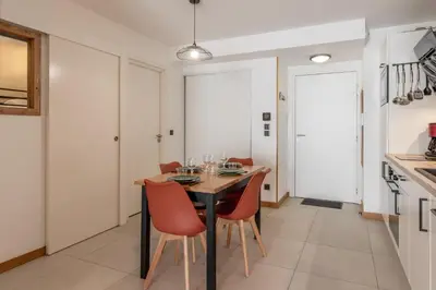 a kitchen and dining room with a table and chairs at Les Ecrins de Kayla -Piscine - Sauna in Les Houches