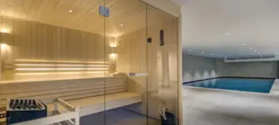 a bathroom with a swimming pool and a glass door at Kandahar de Kayla - Proche remontée - Espace bien-être in Les Houches