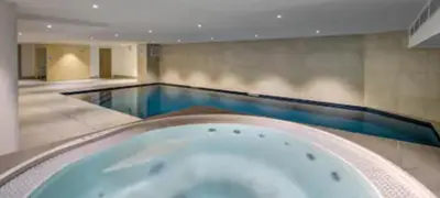 a large swimming pool with a bath tub at Kandahar de Kayla - Proche remontée - Espace bien-être in Les Houches