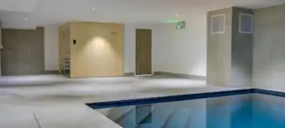 an empty room with a swimming pool and a door at Kandahar de Kayla - Proche remontée - Espace bien-être in Les Houches
