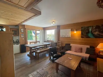 a living room with a couch and a table at Spacious 2 bedroom apt with terrace Chamonix center in Chamonix-Mont-Blanc