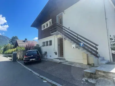 a car parked in front of a building with a parking lot at Spacious 2 bedroom apt with terrace Chamonix center in Chamonix-Mont-Blanc