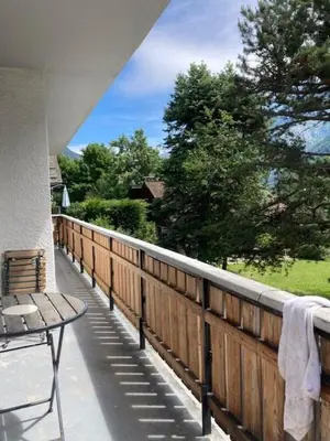 a patio with a wooden fence and a bench on a porch at Spacious 2 bedroom apt with terrace Chamonix center in Chamonix-Mont-Blanc