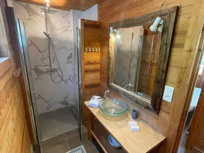 a bathroom with a sink and a glass shower at Spacious 2 bedroom apt with terrace Chamonix center in Chamonix-Mont-Blanc