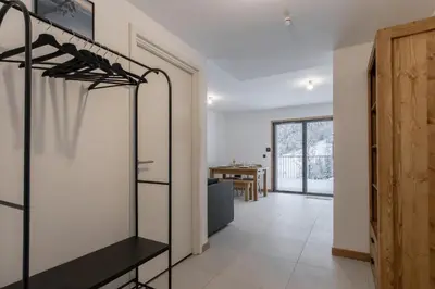 an empty room with a closet and a table at Le Manoir de Kayla - Piscine, Sauna & Vue in Les Houches