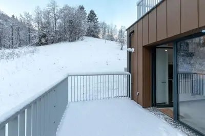 a snow covered walkway next to a building at Le Manoir de Kayla - Piscine, Sauna & Vue in Les Houches