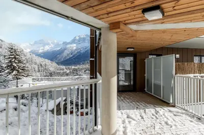 a balcony with a view of snow covered mountains at Le Manoir de Kayla - Piscine, Sauna & Vue in Les Houches