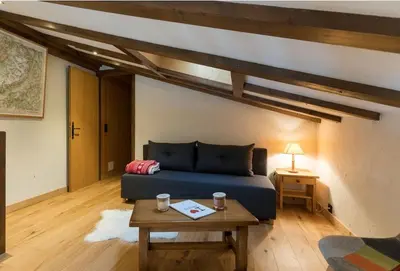 a bedroom with a blue bed and a table at L'Etoile de Megève in Megève