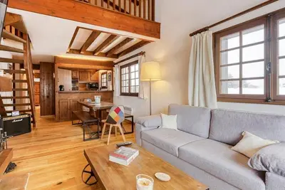 a living room with a couch and a table at L'Etoile de Megève in Megève