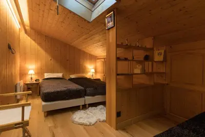 a bedroom with a bed in a wooden cabin at L'Etoile de Megève in Megève