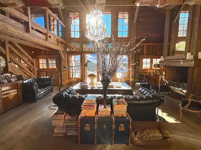 a living room with a couch and a chandelier at Chalet Hermine in Megève
