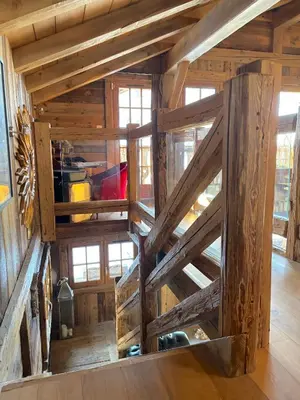 an attic room with wooden walls and wooden floors at Chalet Hermine in Megève
