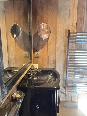 a kitchen with a sink and a mirror at Chalet Hermine in Megève
