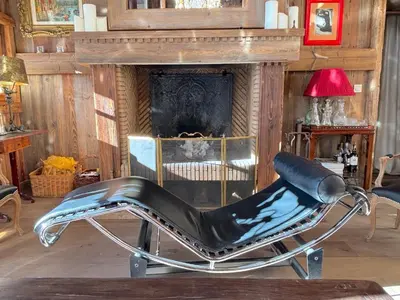 a leather chair sitting in front of a fireplace at Chalet Hermine in Megève
