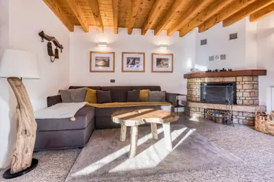 a living room with a couch and a fireplace at Chalet la Chouette - Intimate 2 bedroom demi-chalet ideally located in Chamonix-Mont-Blanc