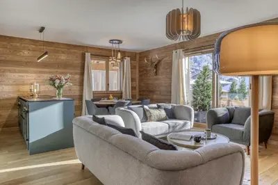a living room with a couch and a table at L'Alezan I Appartement proche du centre de Megève in Megève
