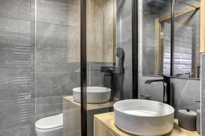 a bathroom with a sink and a toilet at L'Alezan I Appartement proche du centre de Megève in Megève