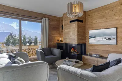 a living room with two chairs and a fireplace at L'Alezan I Appartement proche du centre de Megève in Megève