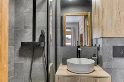 a bathroom with a sink and a mirror at L'Alezan I Appartement proche du centre de Megève in Megève