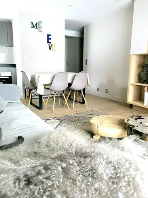 a living room with a table and chairs at Apartment with large terace next Jaillet ski area in Megève