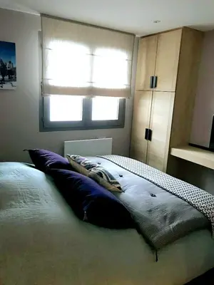 a kitchen with black cabinets and a sink and a window at Apartment with large terace next Jaillet ski area in Megève