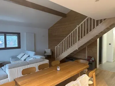 a living room with a couch and a wooden table at L'écrin de Samoëns in Samoëns