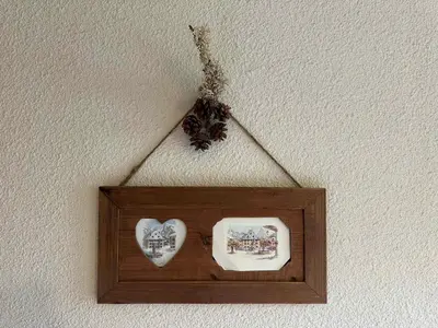 a wooden frame with two hearts on a wall at Charmant studio 3 pers, vue pistes - FR-1-642-106 in Morillon