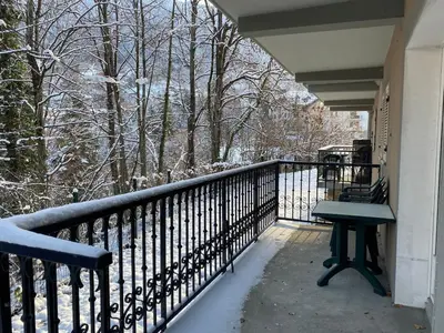 a porch with a bench on a balcony at Appartement pour 6 personnes au pied du téléphérique in Saint-Gervais-les-Bains