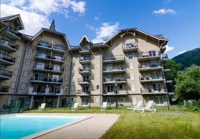 a large apartment building with a swimming pool at Appartement pour 6 personnes au pied du téléphérique in Saint-Gervais-les-Bains