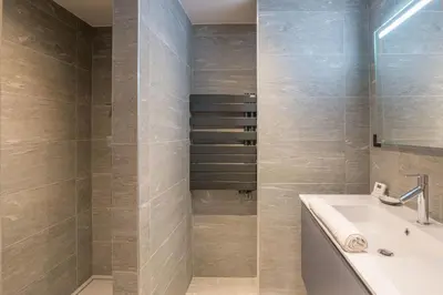 a bathroom with a sink and a bath tub at Appartement Montalis - Welkeys in Megève