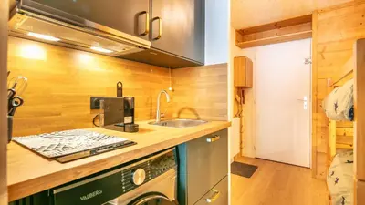 a small kitchen with a sink and a stove at Grand Tetras N111 2P6 in Morillon