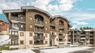 a large apartment building with snow on the ground at Grand Tetras N111 2P6 in Morillon