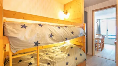 a bedroom with a bunk bed with blue stars on it at Grand Tetras N111 2P6 in Morillon