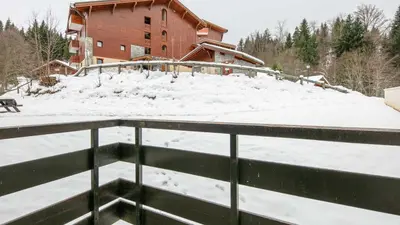 a snow covered roof of a house with a building at Grand Tetras N111 2P6 in Morillon