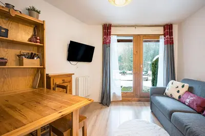 a living room with a couch and a table at Le Cocon des Pistes - Station à 10 minutes in Les Contamines-Montjoie