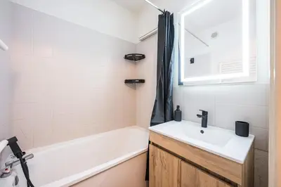 a bathroom with a sink and a bath tub at Le Cocon des Pistes - Station à 10 minutes in Les Contamines-Montjoie