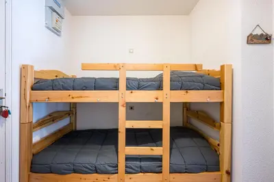 a couple of bunk beds in a room at Le Cocon des Pistes - Station à 10 minutes in Les Contamines-Montjoie